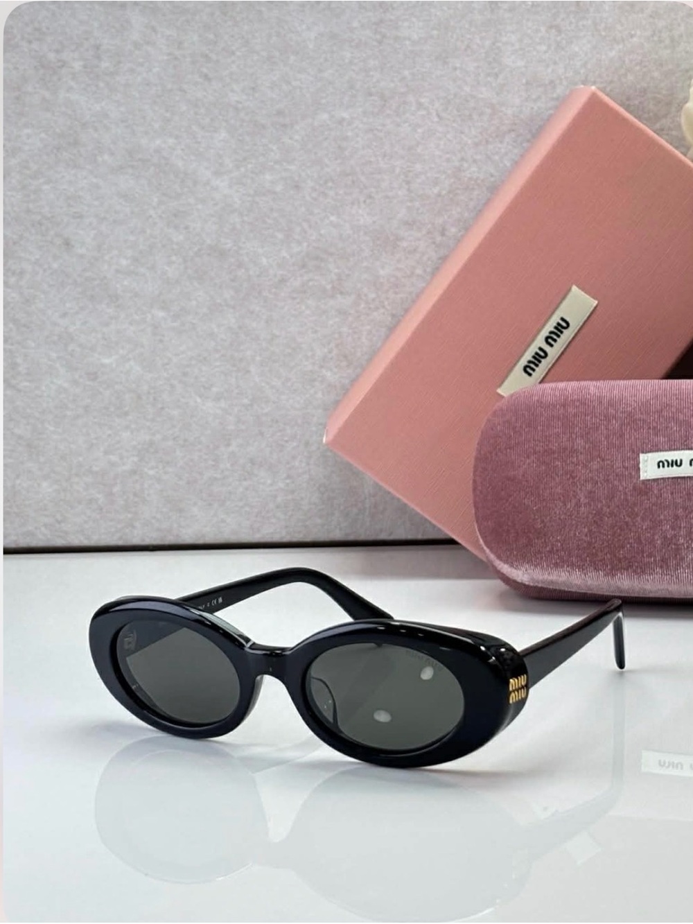 Miu Miu Black Oval Sunglasses with Dark Lenses